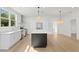 Modern kitchen featuring a large island, stainless steel appliances, and white cabinetry at 1001 E New Orleans Ave, Tampa, FL 33603