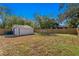 Large backyard with detached garage and wooden fence at 1001 E New Orleans Ave, Tampa, FL 33603