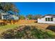 Spacious backyard with wooden fence and neighboring houses at 1001 E New Orleans Ave, Tampa, FL 33603