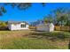 Backyard view of house, detached garage, and fenced lot at 1001 E New Orleans Ave, Tampa, FL 33603