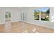 Light-filled living room with hardwood floors and a view of the backyard at 1001 E New Orleans Ave, Tampa, FL 33603