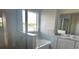 Bright bathroom featuring tiled walls, tub and shower, and spacious vanity at 16021` 7Th E Ave, Bradenton, FL 34212