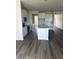 Open kitchen featuring stainless appliances, gray countertops and central island at 16021` 7Th E Ave, Bradenton, FL 34212