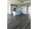 Open concept kitchen with stainless appliances, light cabinetry, and central island at 16021` 7Th E Ave, Bradenton, FL 34212