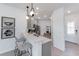 Modern kitchen with gray cabinets, quartz countertops, and breakfast bar at 18840 Indian Rock Pl, Lakewood Ranch, FL 34211