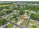 An aerial view showcases a well-located home within a vibrant residential neighborhood with mature trees and manicured lawns at 311 Sugar Creek Dr, Plant City, FL 33563
