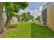 Lush green backyard featuring a well-maintained lawn and mature shade trees, creating a private outdoor space at 311 Sugar Creek Dr, Plant City, FL 33563