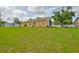 Expansive backyard with lush green grass, with view of the exterior of the home at 311 Sugar Creek Dr, Plant City, FL 33563