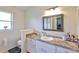 Bathroom with vanity, large mirror, natural light, and an adjacent toilet area at 311 Sugar Creek Dr, Plant City, FL 33563