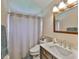 Nicely-updated bathroom with vanity, large mirror, shower-tub combo, and neutral colors at 311 Sugar Creek Dr, Plant City, FL 33563