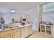 Bright kitchen featuring tile flooring, white cabinets, and modern appliances at 311 Sugar Creek Dr, Plant City, FL 33563