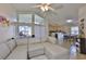 Open living room featuring a large sectional sofa, vaulted ceilings, and bright natural light at 311 Sugar Creek Dr, Plant City, FL 33563
