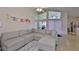 Open living room featuring a large sectional sofa, vaulted ceilings, and bright natural light at 311 Sugar Creek Dr, Plant City, FL 33563