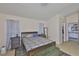 Tranquil primary bedroom with a dark wood bed, light walls, and a view into the bathroom at 311 Sugar Creek Dr, Plant City, FL 33563