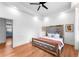 Spacious bedroom with hardwood floors and a large bed with mirrored headboard at 3506 N Arlington Ave, Tampa, FL 33603