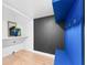Mudroom with blue bench, hooks, and dark gray accent wall at 3506 N Arlington Ave, Tampa, FL 33603