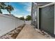Side yard with concrete path and white fence at 3506 N Arlington Ave, Tampa, FL 33603