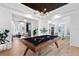 Open game room with pool table, hardwood floors, and views into adjacent living areas at 3506 N Arlington Ave, Tampa, FL 33603