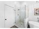 Bathroom featuring a glass-enclosed shower with subway tile and a door to the exterior at 3506 N Arlington Ave, Tampa, FL 33603