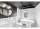 Updated bathroom with stylish fixtures, stand alone tub, and black and white flooring at 3506 N Arlington Ave, Tampa, FL 33603