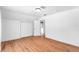 Bedroom featuring neutral walls, hardwood floors, a window and built in closet at 3506 N Arlington Ave, Tampa, FL 33603