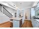 Modern kitchen with light blue cabinets, granite island, and stainless steel appliances at 3506 N Arlington Ave, Tampa, FL 33603