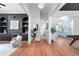 Bright entryway with hardwood floors, offering views of the living room and kitchen at 3506 N Arlington Ave, Tampa, FL 33603