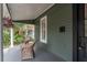 Relaxing front porch featuring wicker chairs and hanging plants at 3506 N Arlington Ave, Tampa, FL 33603