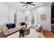 Spacious living room with hardwood floors, a cozy sectional sofa, and a fireplace at 3506 N Arlington Ave, Tampa, FL 33603