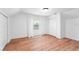 Simple bedroom with hardwood floors and window at 3506 N Arlington Ave, Tampa, FL 33603