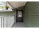 Covered back porch with exterior access and black door at 3506 N Arlington Ave, Tampa, FL 33603