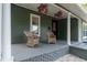 Inviting front porch with wicker chairs and hanging plants at 3506 N Arlington Ave, Tampa, FL 33603