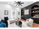 Spacious living room with hardwood floors, a cozy sectional sofa, and a fireplace at 3506 N Arlington Ave, Tampa, FL 33603