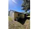 Rear view of house with AC unit and landscaping at 4215 E Bay Dr # 1013B, Clearwater, FL 33764