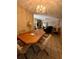 Bright dining room with wood table and chairs, offering views into the living room at 4215 E Bay Dr # 1013B, Clearwater, FL 33764