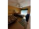 Guest bedroom with two twin beds, wood flooring, and a ceiling fan at 4215 E Bay Dr # 1013B, Clearwater, FL 33764