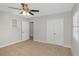 Spacious bedroom with neutral walls, ceiling fan, and double door closet at 4601 8Th N Ave, St Petersburg, FL 33713