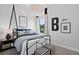 Stylish bedroom with metal bed frame and black and white decor at 5015 Stoney Point Gln, Lakewood Ranch, FL 34211