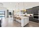 Bright kitchen with white and gray cabinetry, breakfast bar, and view to the backyard at 5015 Stoney Point Gln, Lakewood Ranch, FL 34211