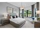 Bright bedroom with large window, comfortable bed and sitting area at 5015 Stoney Point Gln, Lakewood Ranch, FL 34211