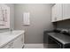 Bright laundry room with white cabinets and stainless steel appliances at 5015 Stoney Point Gln, Lakewood Ranch, FL 34211