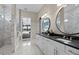 Large bathroom with double vanity, marble flooring, and walk-in shower at 5015 Stoney Point Gln, Lakewood Ranch, FL 34211