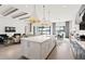 Open concept kitchen boasts white cabinetry, large island, and stainless steel appliances at 5015 Stoney Point Gln, Lakewood Ranch, FL 34211