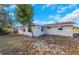 Side yard view, showing the home's exterior and landscaping at 5026 Flora Ave, Holiday, FL 34690