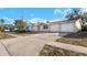 Front view of a single-story home with a two-car garage at 5026 Flora Ave, Holiday, FL 34690