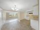 Bright kitchen featuring white cabinets and granite countertops at 5026 Flora Ave, Holiday, FL 34690