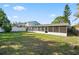 Spacious backyard with a screened-in porch and lush green lawn at 5419 Denver Ne St, St Petersburg, FL 33703