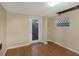 Small bedroom with wood floors and exterior access at 615 16Th Nw St, Largo, FL 33770