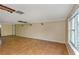Living room features hardwood floors and wall damage at 615 16Th Nw St, Largo, FL 33770