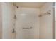 Shower stall with beige tile and grab bars at 615 16Th Nw St, Largo, FL 33770